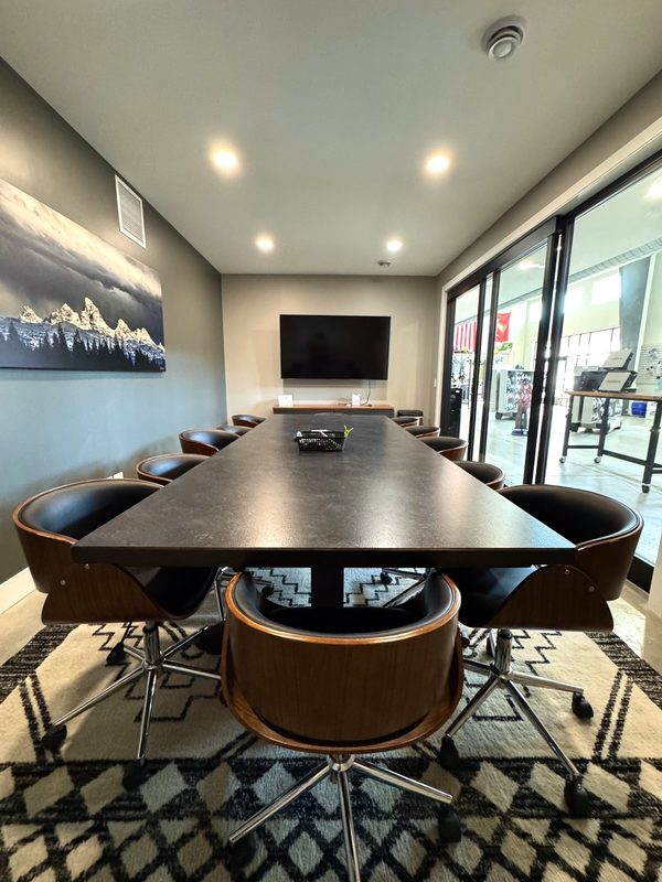 Conference room with a polished boardroom table, cleaned and ready
