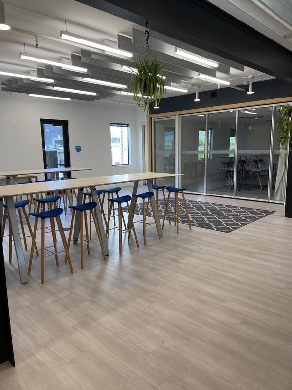 Open coworking commons with communal tables after service