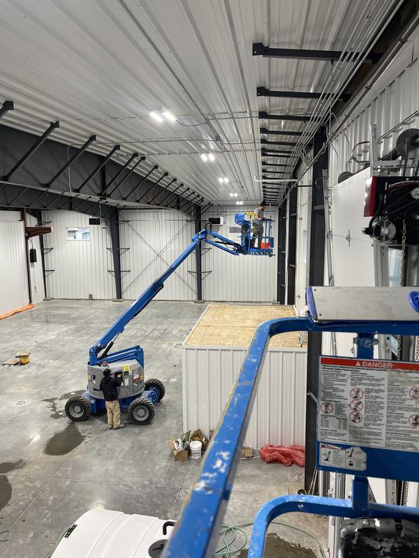Boom lift positioned against the hangar wall