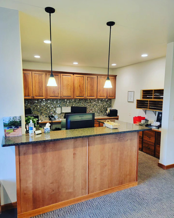 Real estate office reception desk with granite counter and fresh carpet